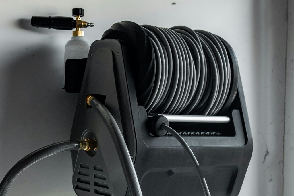 Wall-mounted high-pressure hose reel with a foam cannon attachment